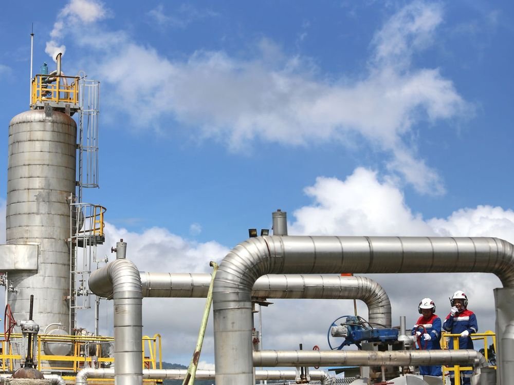 Plant operators inspecting process pipework