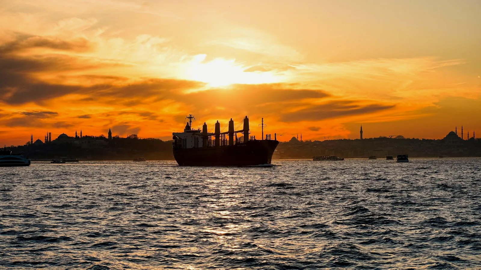 A product tanker lying at anchor at golden hour