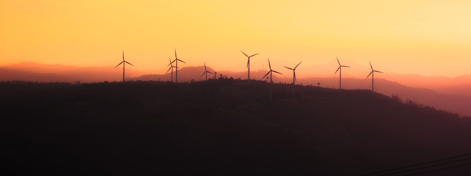 Wind turbines on a ridge at sunset
